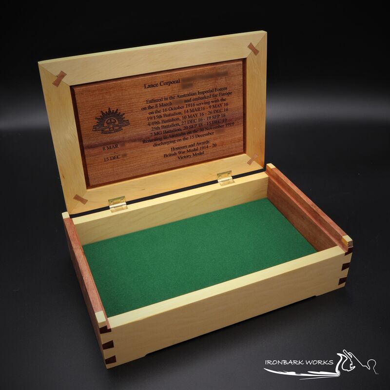 Home to the medals of a Lance Corporal who served in the A.I.F during World War I, this exquisite Huon Pine and Myrtle medal box is a fitting tribute. The lush green velour lining provides a perfect backdrop for these cherished medals, while the 3rd edition Rising Sun Badge proudly adorns the box.
